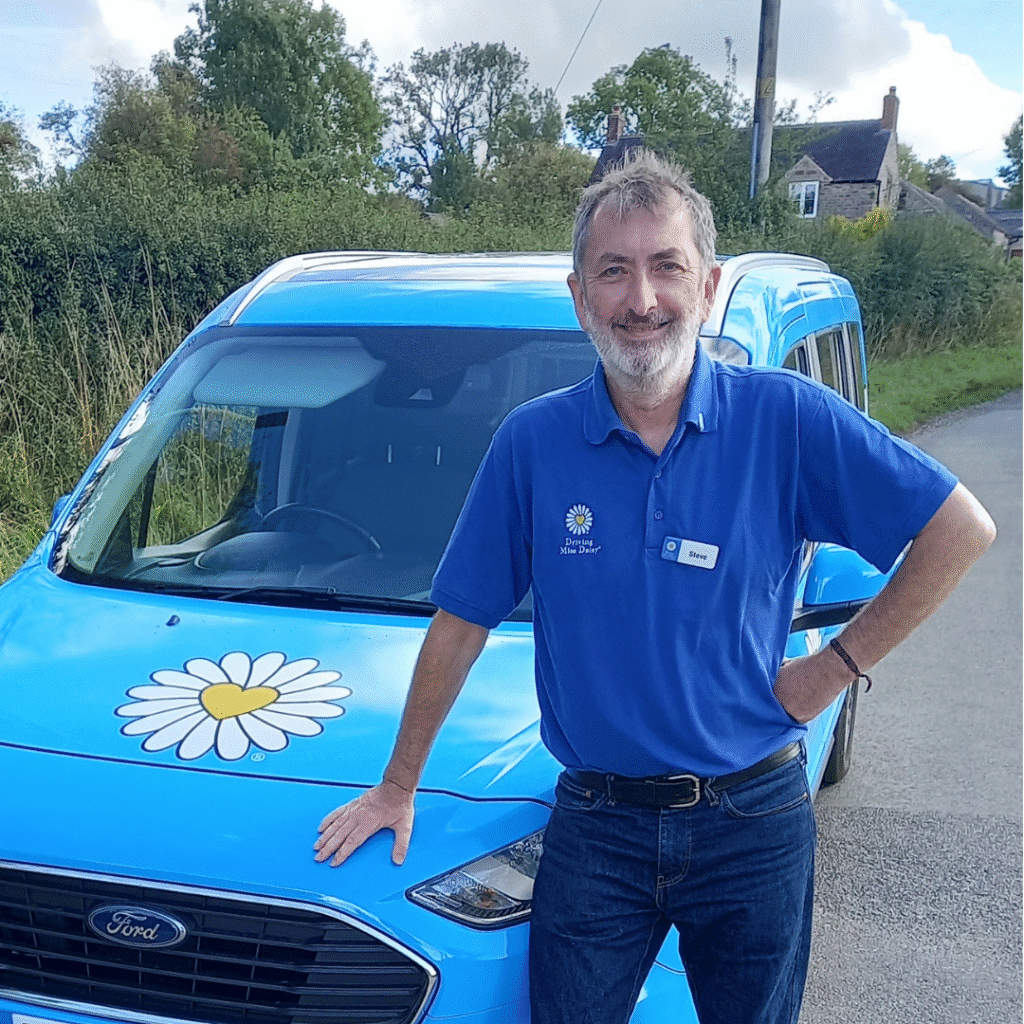 Steve Tilsley, Driving Miss Daisy Derbyshire Dales standing beside blue wheelchair accessible vehicle with daisy logo